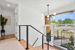 Entryway with light wood-style floors, a chandelier, and recessed lighting