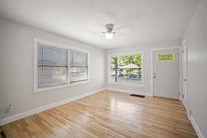 Living room featuring light wood-style floors and ceiling fan