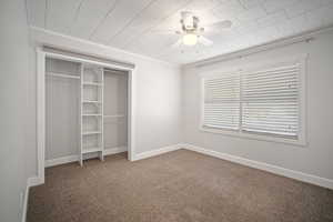 Carpeted master bedroom with a closet, and ceiling fan