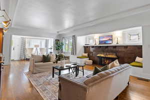 Living area featuring wood finished floors and a tiled fireplace