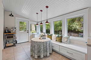 Sunroom / solarium with plenty of natural light and vaulted ceiling and heated floors