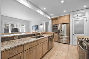 Kitchen with recessed lighting, appliances with stainless steel finishes
