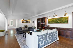 Living room with beautiful built-in shelving and a tray ceiling