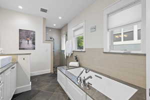 Full bathroom featuring a shower stall, vanity, a bath, recessed lighting, and heated floors