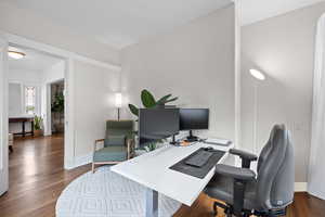 Office space featuring wood flooring and baseboards