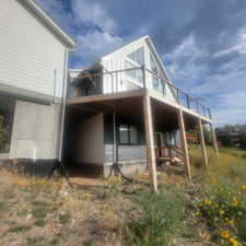 View of side of home with a deck