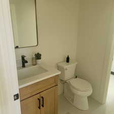 Half bath with vanity and light tile patterned floors