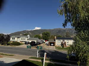 View of asphalt street with a mountain view, sidewalks, and curbs