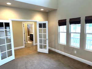 Unfurnished room featuring french doors, recessed lighting, and carpet