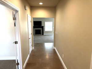 Hall with dark carpet and recessed lighting