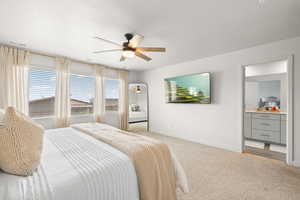 Bedroom featuring carpet flooring, connected bathroom, and a ceiling fan
