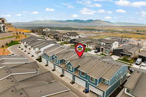 Aerial perspective of suburban area featuring a mountainous background