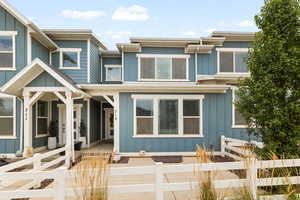 View of front of property featuring a fenced front yard, board and batten siding, and a gate