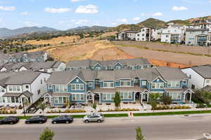 Aerial perspective of suburban area featuring a mountainous background