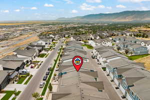 Aerial perspective of suburban area featuring a mountainous background