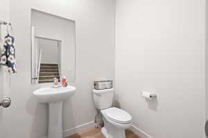 Bathroom with wood finished floors and toilet