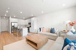 Living room featuring light wood-type flooring and recessed lighting