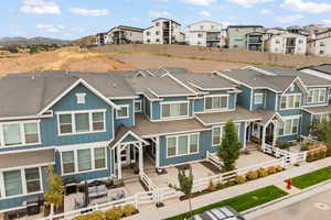 View of front facade featuring roof with shingles, a residential view, an outdoor hangout area, and board and batten siding