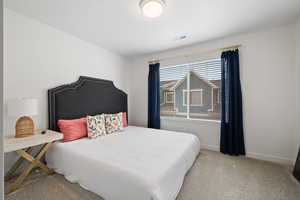 Bedroom with light carpet and baseboards