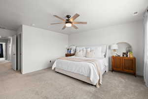 Carpeted bedroom featuring ceiling fan and baseboards