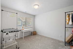 Office space featuring light carpet and baseboards
