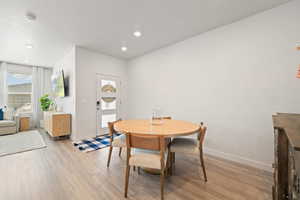 Dining room featuring light wood-type flooring and recessed lighting