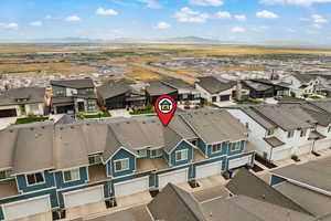 Aerial view of residential area featuring a mountainous background