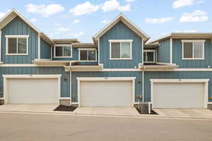 View of front of property featuring board and batten siding and an attached garage