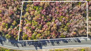 Aerial view of property and surrounding area featuring property parcel outlined