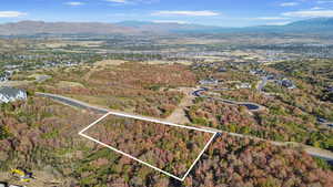 Aerial overview of property's location featuring property parcel outlined and mountains