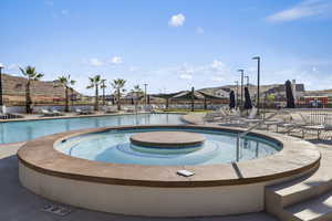 Community pool featuring a patio area and a community hot tub