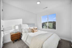 Bedroom featuring carpet and baseboards