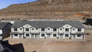 View of front of home with stucco siding and a mountain view