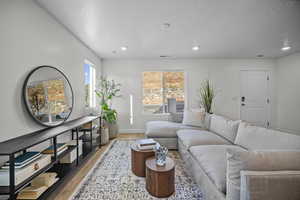 Living room featuring wood finished floors and recessed lighting