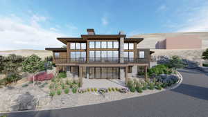 Back of house featuring a chimney and a balcony
