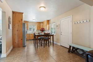 Dining room with light tile patterned flooring and baseboards