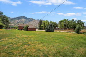 View of yard featuring a mountain view and a view of countryside