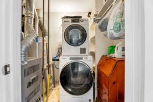 Laundry room with stacked washing machine and dryer