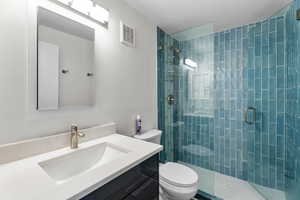 Bathroom featuring vanity and a shower stall