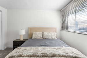 Bedroom featuring carpet floors and a textured ceiling