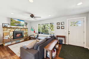 Living area featuring recessed lighting, a fireplace, wood finished floors, and a ceiling fan