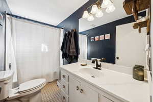 Bathroom featuring vanity, tile patterned flooring, and shower / tub combo