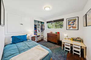 Bedroom featuring dark wood finished floors and a closet