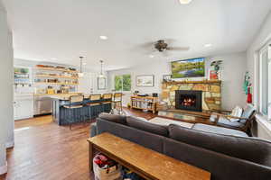 Living room featuring plenty of natural light, light wood-style floors, recessed lighting, and a fireplace