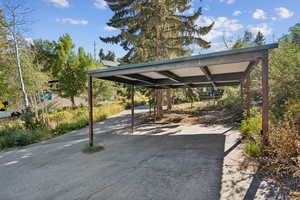 View of parking with asphalt driveway
