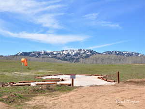 View of mountain backdrop featuring rural landscape