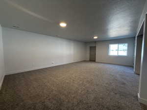 Unfurnished room featuring carpet, recessed lighting, and a textured ceiling