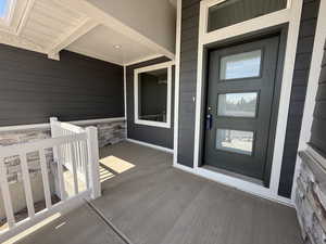 View of exterior entry with stone siding