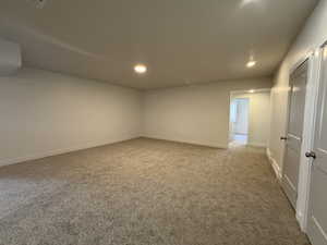 Empty room featuring light colored carpet and recessed lighting