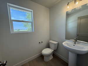 Bathroom with baseboards and wood finished floors